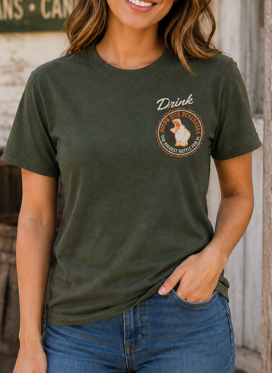 Woman wearing the Hippo Size® Beverage – Texan Size Drink Tee showcasing the vintage chest logo and classic Texas soda nostalgia.
