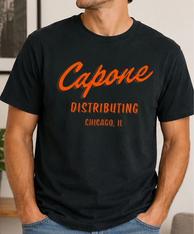 Man wearing the Al Capone SMVT Exclusive Unisex Graphic Tee with vintage Capone Distributing Chicago, Illinois artwork on a black T-shirt.