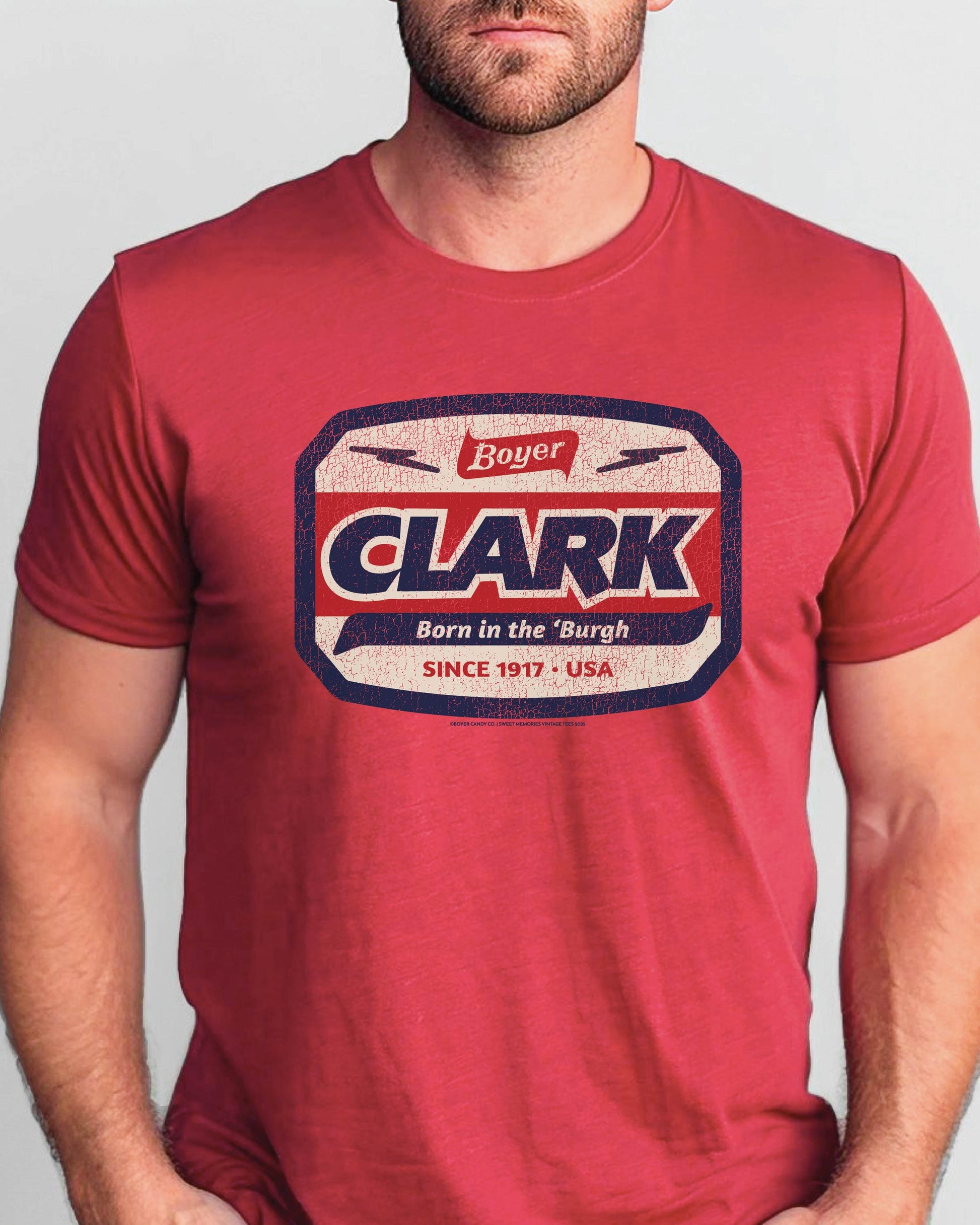 Man wearing the officially licensed Boyer® Clark Bar® Born in the 'Burgh vintage candy unisex graphic T-shirt celebrating Pittsburgh heritage.
