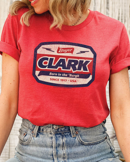 Woman wearing the officially licensed Boyer® Clark Bar® Born in the 'Burgh vintage candy unisex graphic T-shirt featuring a retro Pittsburgh pride design.