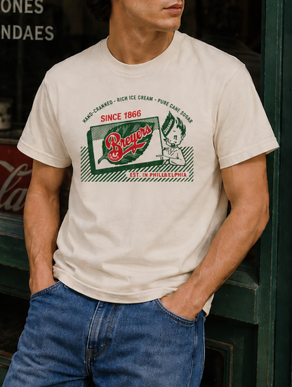 Man wearing a Breyers Ice Cream Vintage 1950s Advertisement Unisex Tee showcasing classic mid-century ice cream branding and retro graphics.