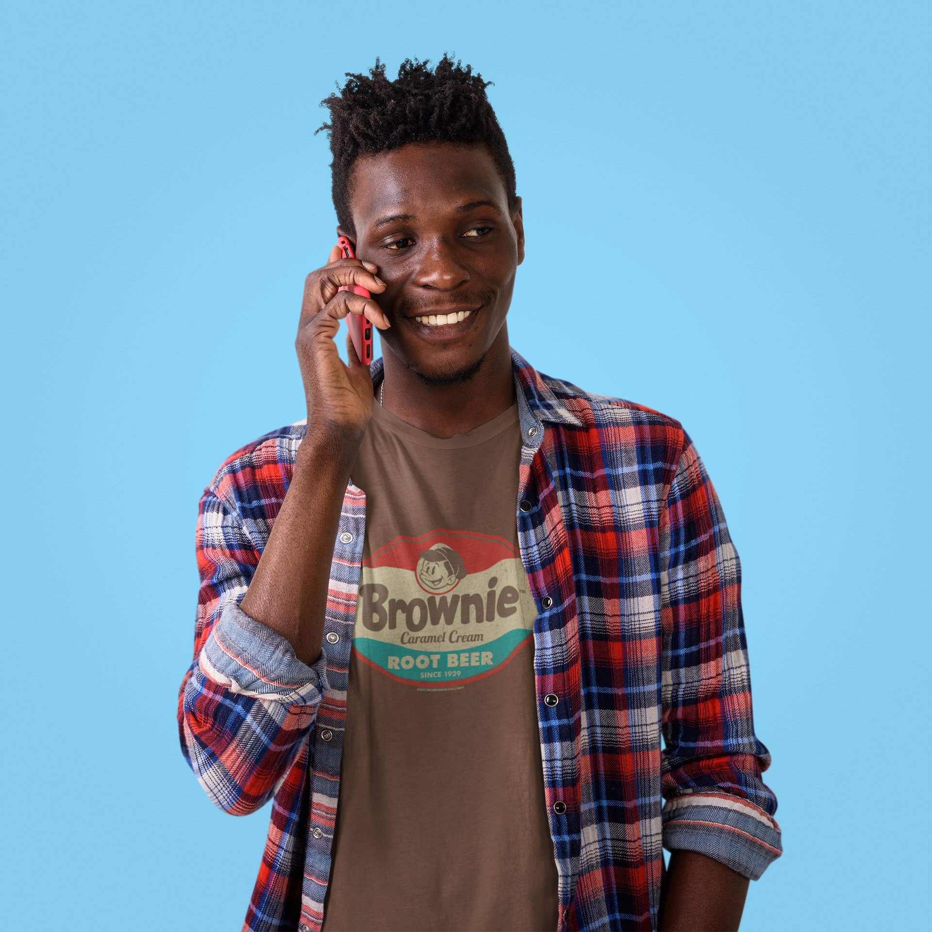Man wearing the Brownie™ Caramel Cream Root Beer Tee featuring a vintage Brownie™ root beer graphic on a unisex T-shirt.