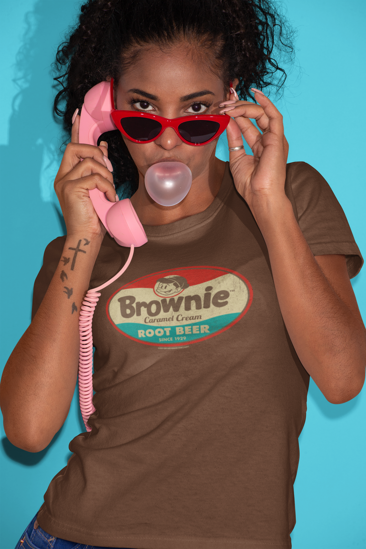Woman wearing the Brownie™ Caramel Cream Root Beer Tee featuring a vintage Brownie™ root beer graphic on a unisex T-shirt.
