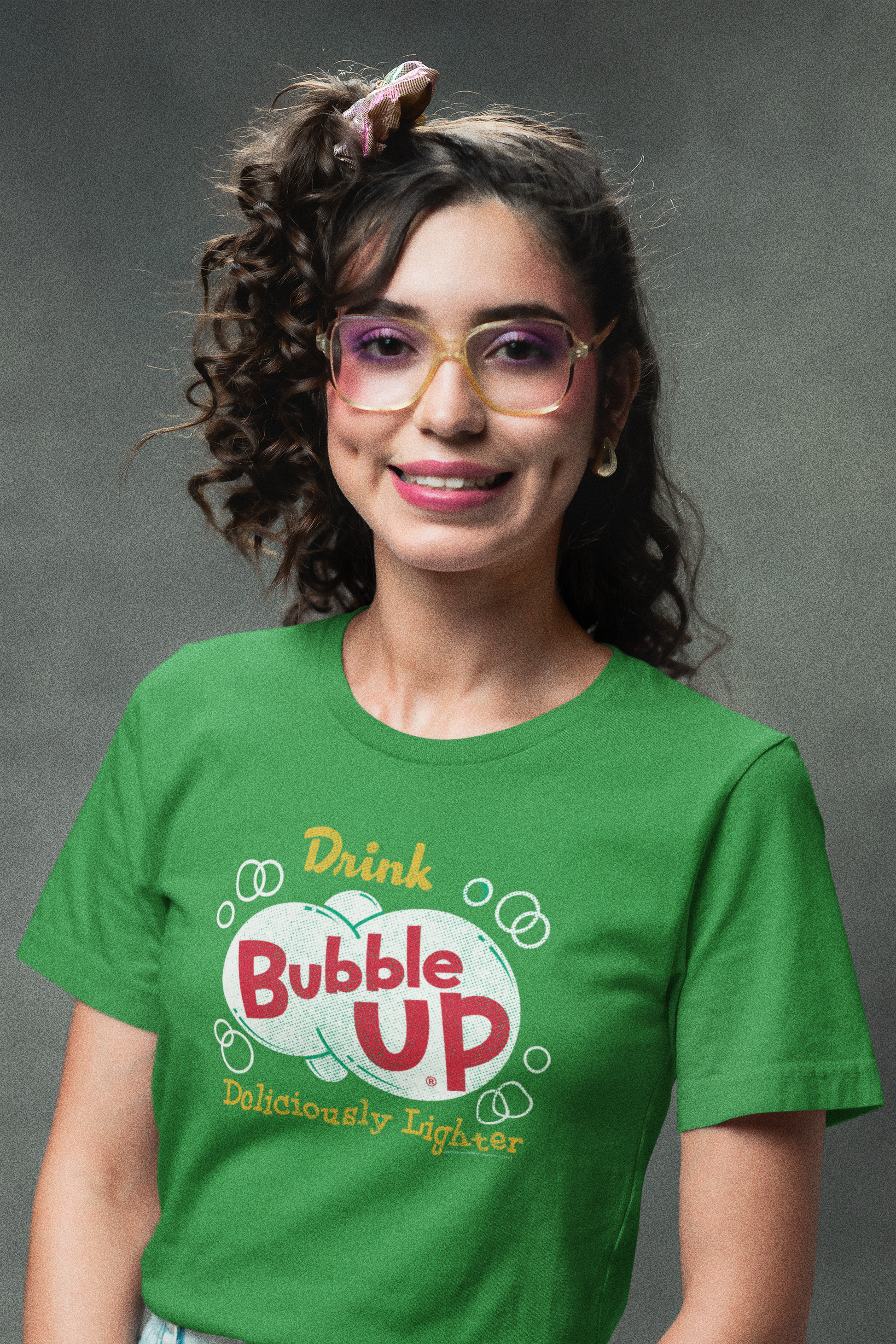 Woman wearing the Bubble Up® Deliciously Lighter Tee in heather green featuring a vintage Bubble Up soda graphic