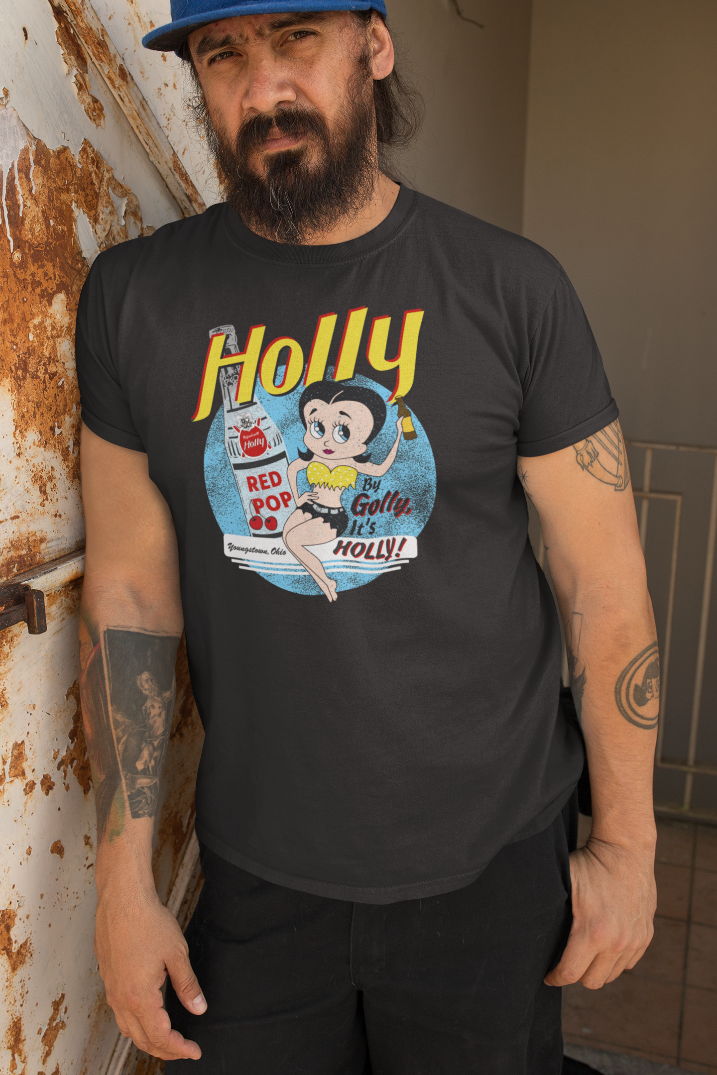 Man wearing the By Golly, It's Holly! Tee featuring vintage Holly soda artwork on a comfortable unisex graphic T-shirt.