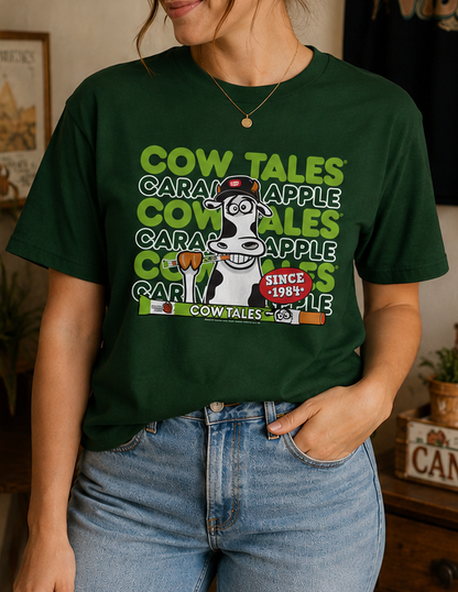 Female model wearing the Goetze's Cow Tales Caramel Apple Brand Colors graphic T-shirt styled with jeans for a casual fall look.