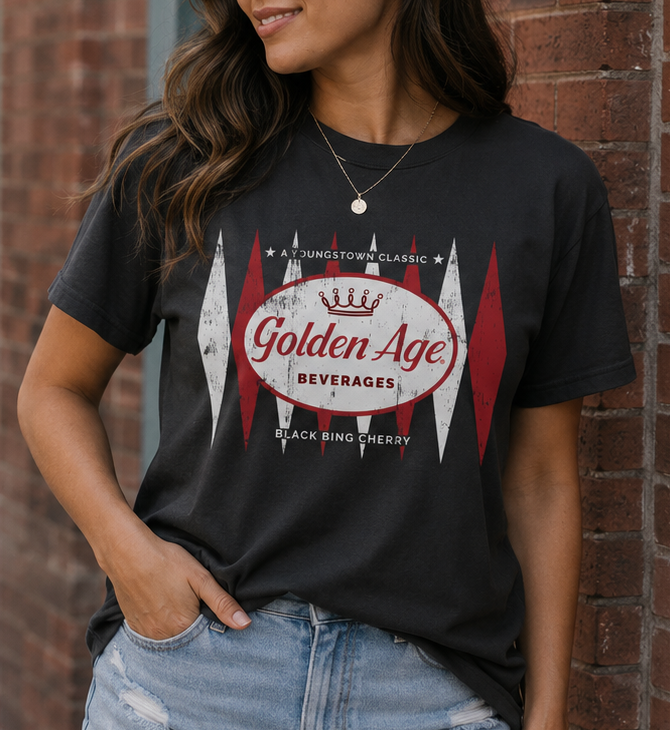 Woman wearing the Golden Age Retro Black Bing Cherry Logo vintage soda unisex graphic T-shirt featuring a distressed classic soda design inspired by Youngstown.