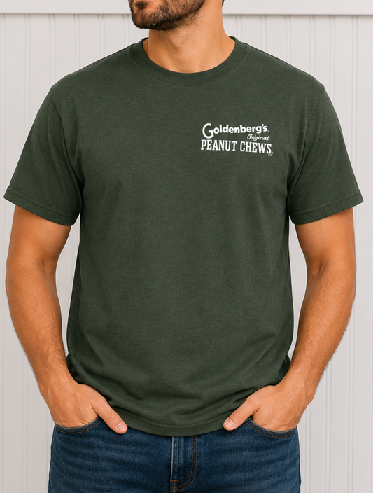 Male model wearing the front of the GOLDENBERG'S® PEANUT CHEWS® Philly Born & Raised Skyline Barcode Tee featuring the classic chest logo graphic.
