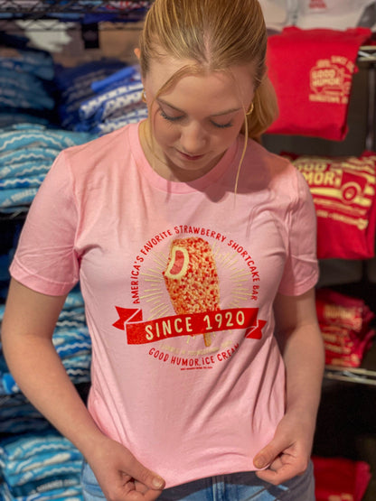 Woman wearing a Good Humor™ Ice Cream Strawberry Shortcake 1920 Tee featuring a nostalgic strawberry shortcake ice cream bar graphic.