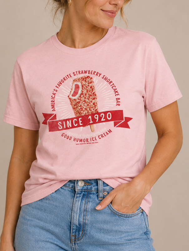 Woman wearing a Good Humor™ Ice Cream Strawberry Shortcake 1920 Tee featuring a nostalgic strawberry shortcake ice cream bar graphic.