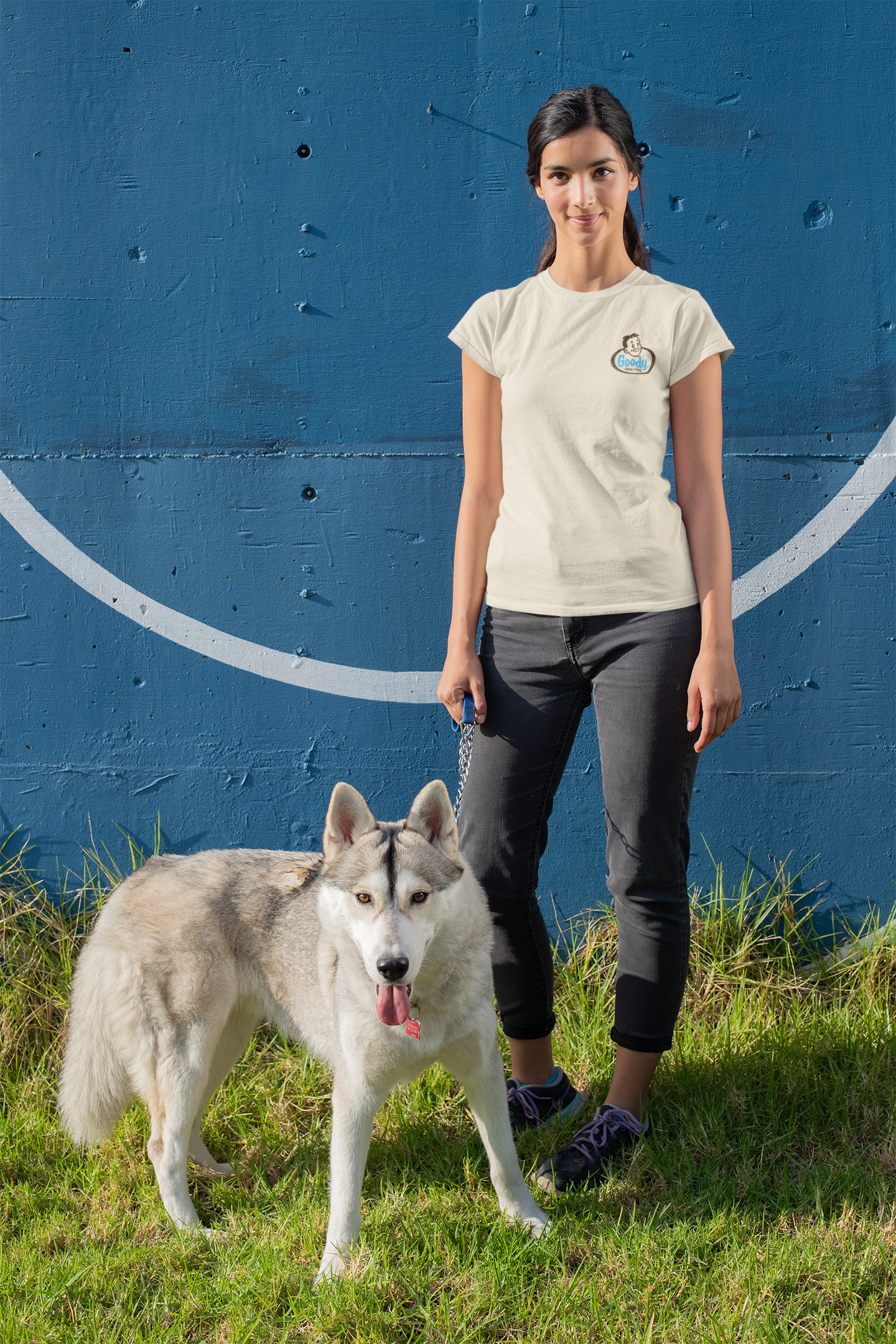 Woman wearing the Goody® Since 1923 Tee featuring a vintage candy logo on a casual unisex graphic t-shirt.