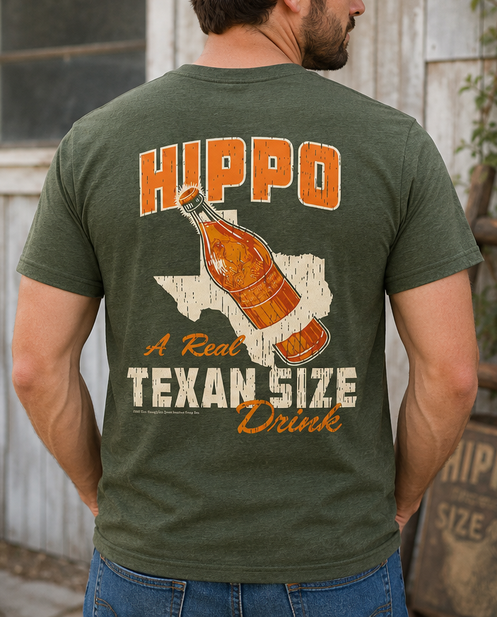 Man wearing the Hippo Size® Beverage – Texan Size Drink Tee displaying the large back graphic inspired by vintage Texas soft drink advertising.