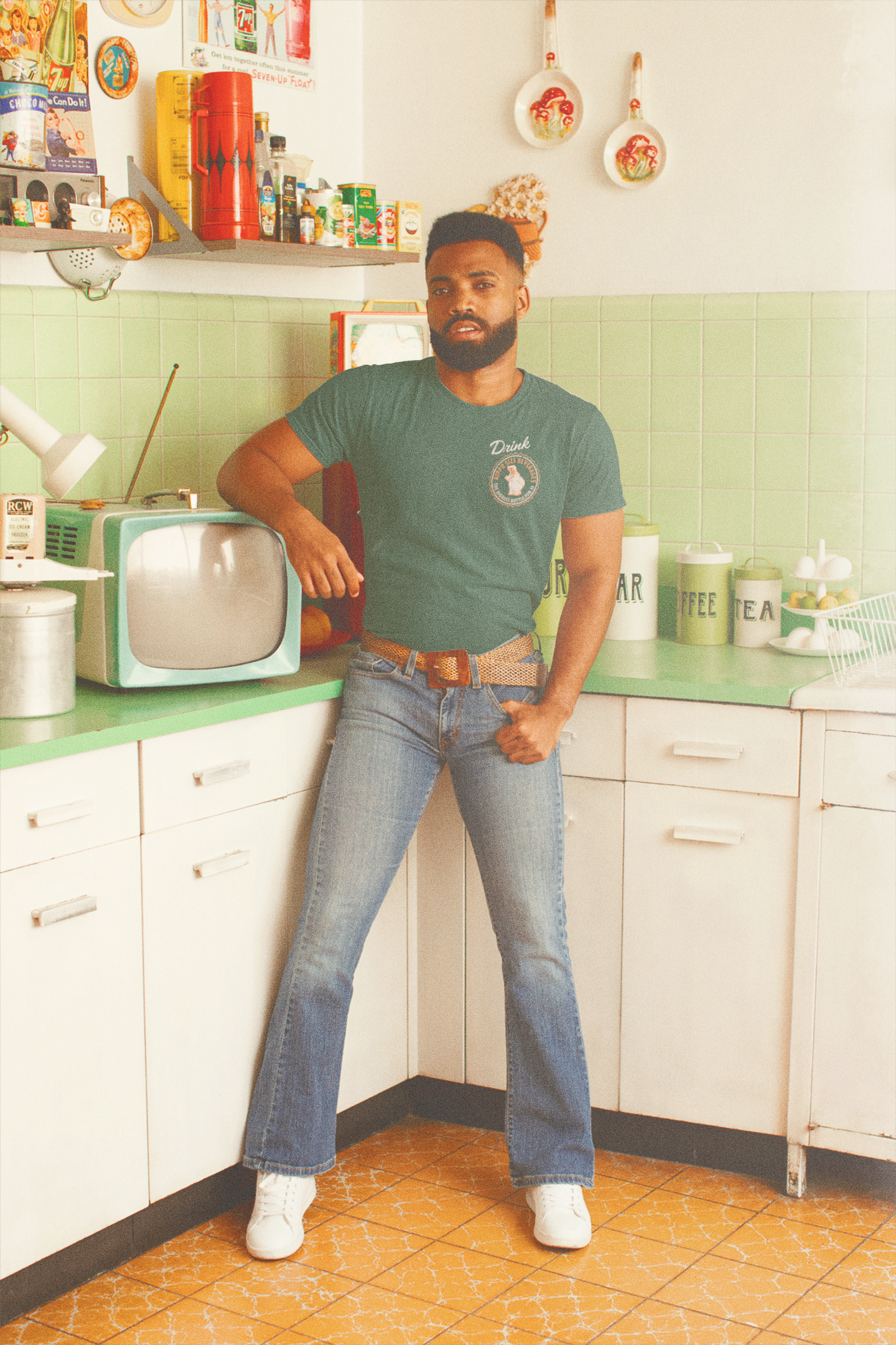 Man wearing the Hippo Size® Beverage – Texan Size Drink Tee chest graphic inspired by vintage Texas soft drink advertising.