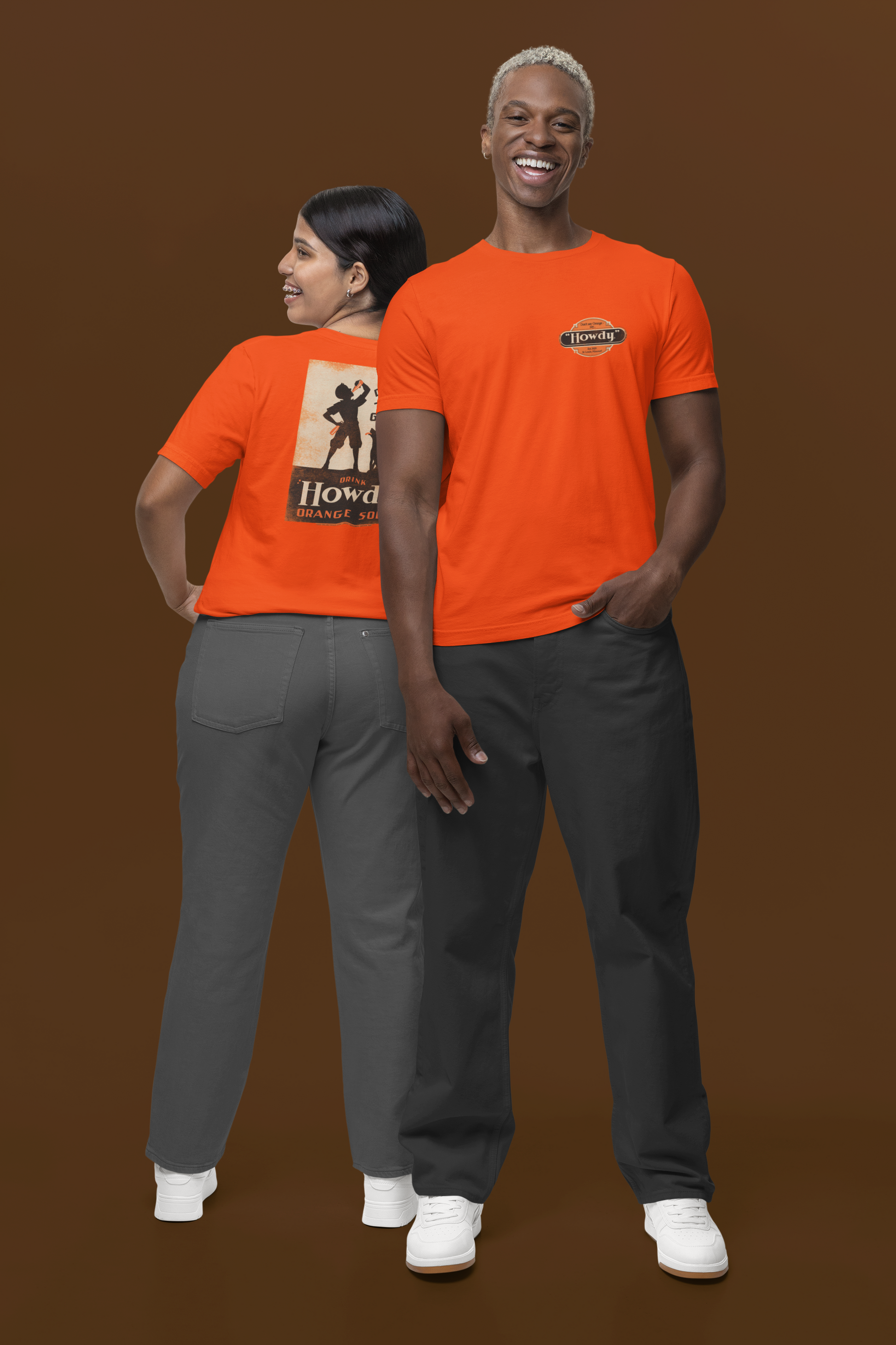 Two people wearing the Howdy® Dog-Gon Good Orange Soda Tee featuring a vintage orange soda graphic on a unisex T-shirt.