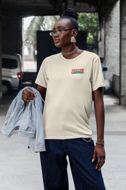 Female model wearing the Jersey Creme® The Perfect Drink Tee showcasing nostalgic Jersey Creme® artwork and classic beverage branding.