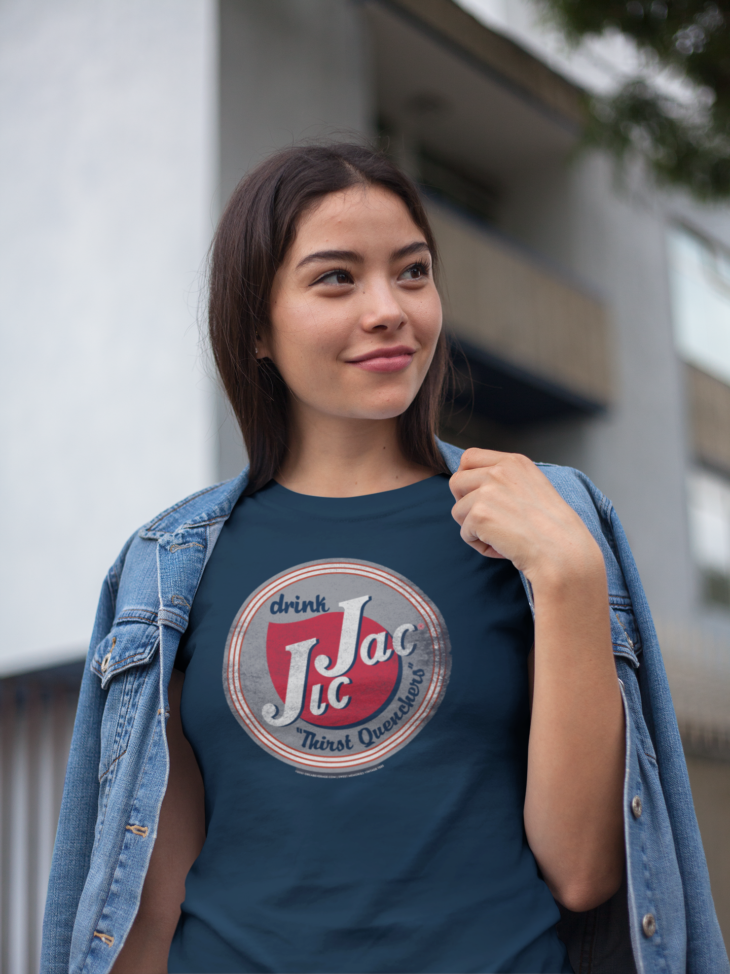 Female model wearing the Jic Jac® Drink! Thirst Quenchers Tee showcasing nostalgic Jic Jac® artwork and vintage soda branding.