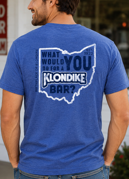 Male model wearing the Klondike® Birthplace of Klondike Ohio t-shirt with vintage chest logo on a blue heather tee.