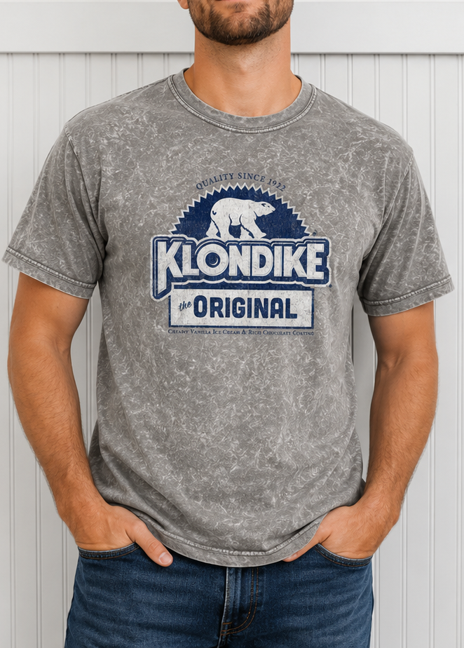 Man wearing a Klondike® Foil Wrapper Since 1922 mineral wash t-shirt featuring the classic Klondike polar bear logo and vintage frozen treat graphic.