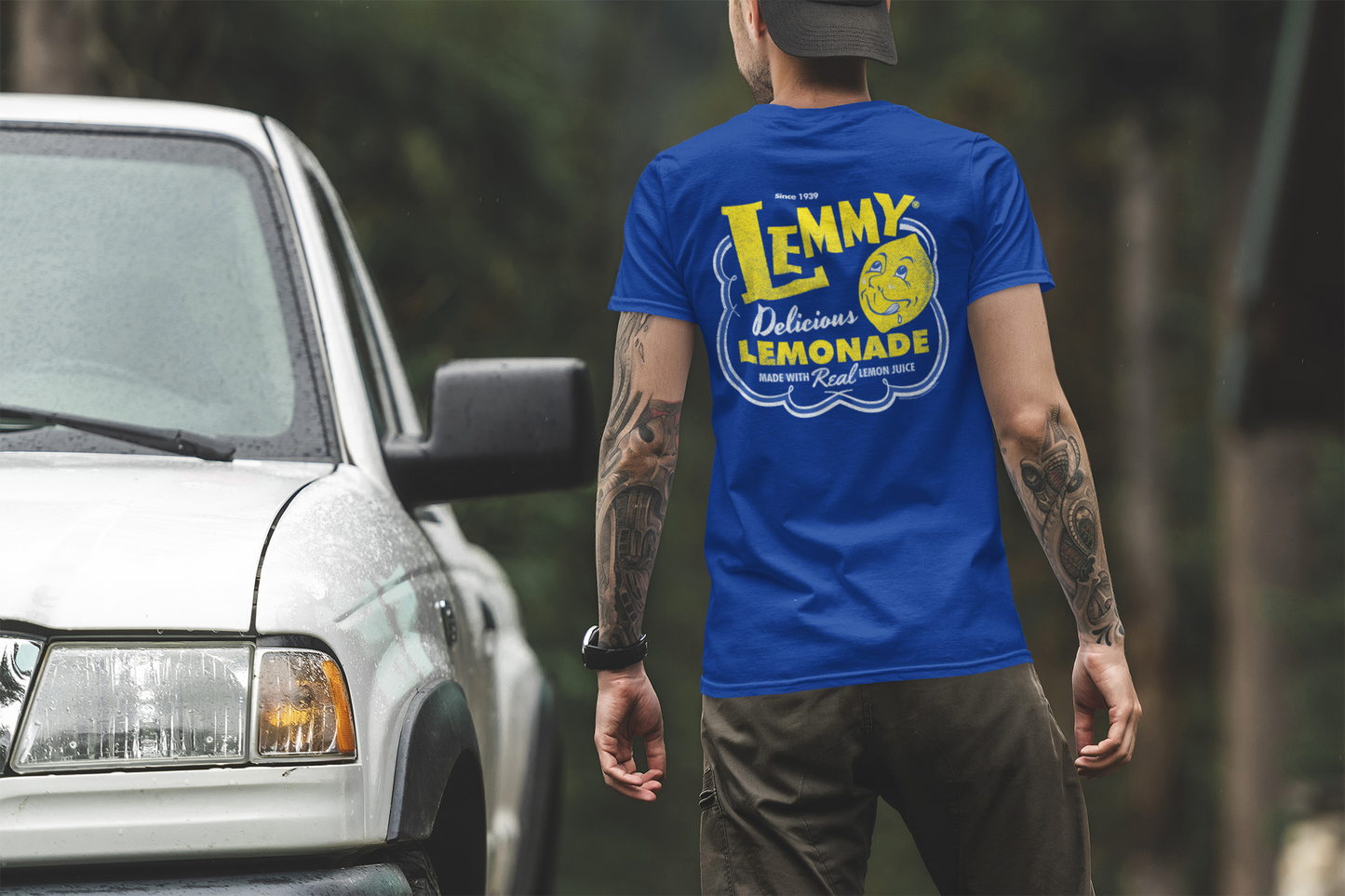 Male model wearing the Lemmy® Lemme Have a Lemmy® Lemonade Tee featuring a classic retro lemonade graphic.