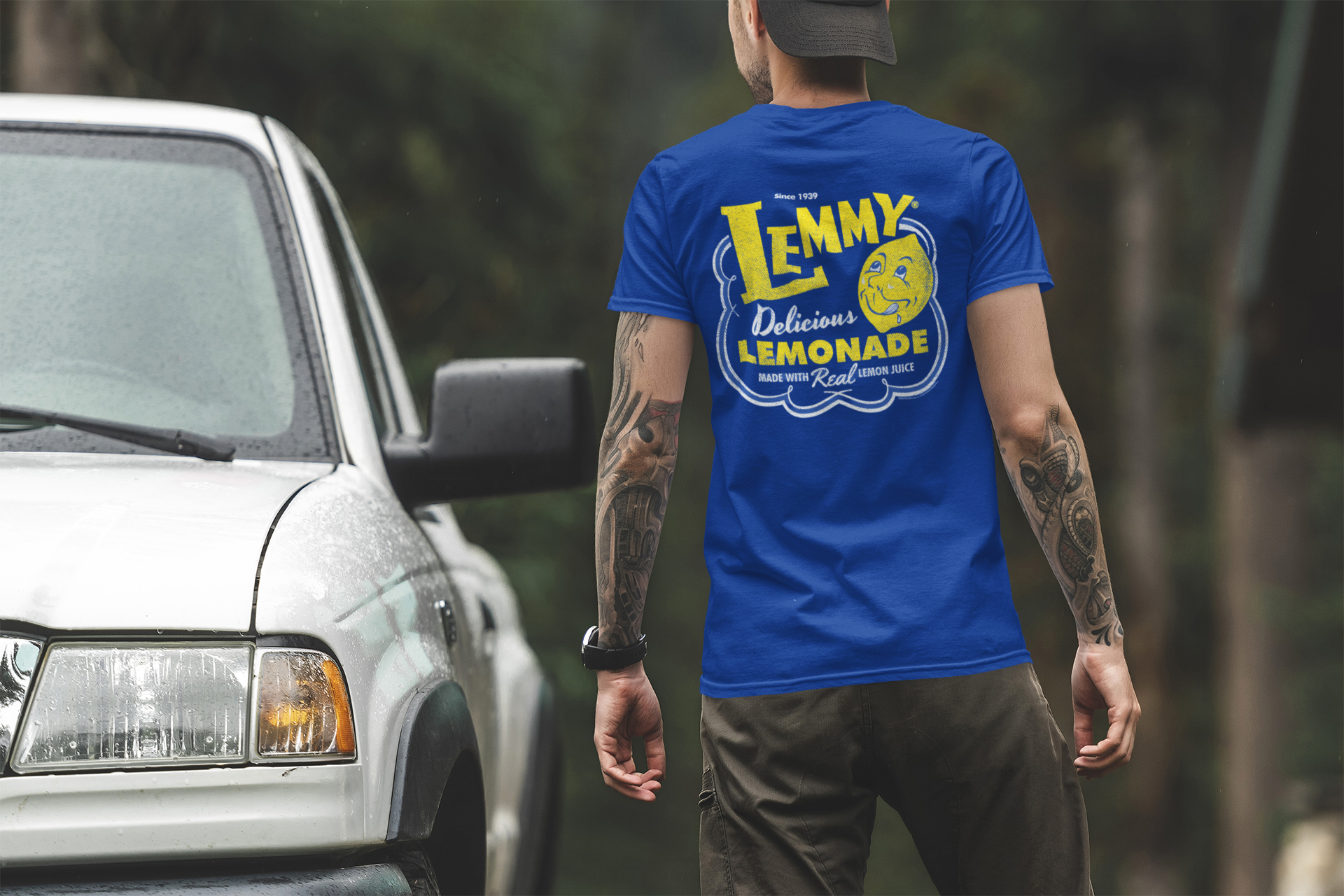 Male model wearing the Lemmy® Lemme Have a Lemmy® Lemonade Tee featuring a classic retro lemonade graphic.