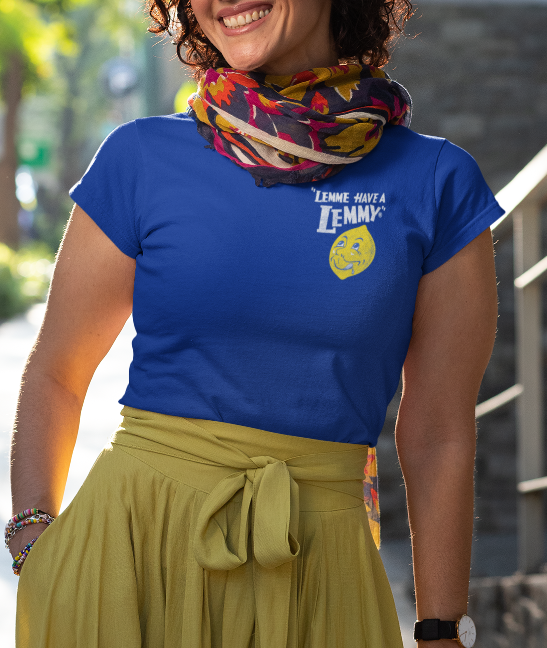 Female model wearing the Lemmy® Lemme Have a Lemmy® Lemonade Tee with nostalgic vintage lemonade artwork.