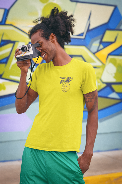 Man wearing the Officially Licensed Lemmy® Lemonade Tee featuring the vintage Lemmy® logo on the front left chest of a bright yellow unisex graphic T-shirt.