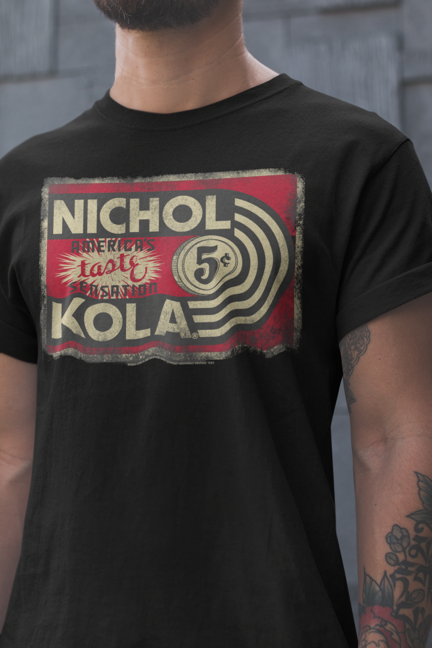 Male model wearing the Nichol Kola® Vintage Sign Tee featuring a retro soft drink sign graphic.