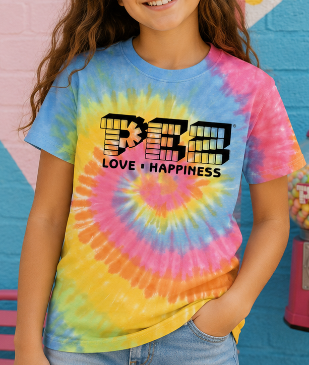 Officially licensed PEZ® Love & Happiness Youth Tie-Dye T-shirt styled in a bright, playful lifestyle setting celebrating retro candy nostalgia.