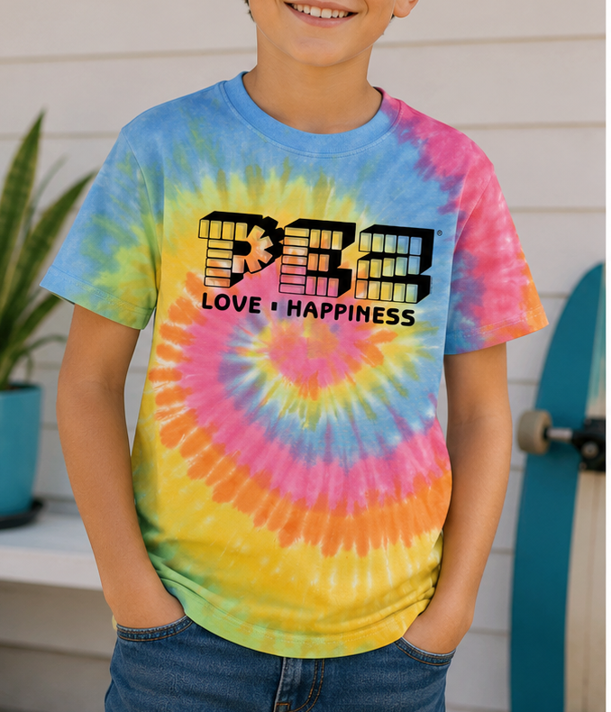 Child wearing the Officially Licensed PEZ® Love & Happiness Youth Tie-Dye Tee featuring a colorful retro PEZ® graphic.