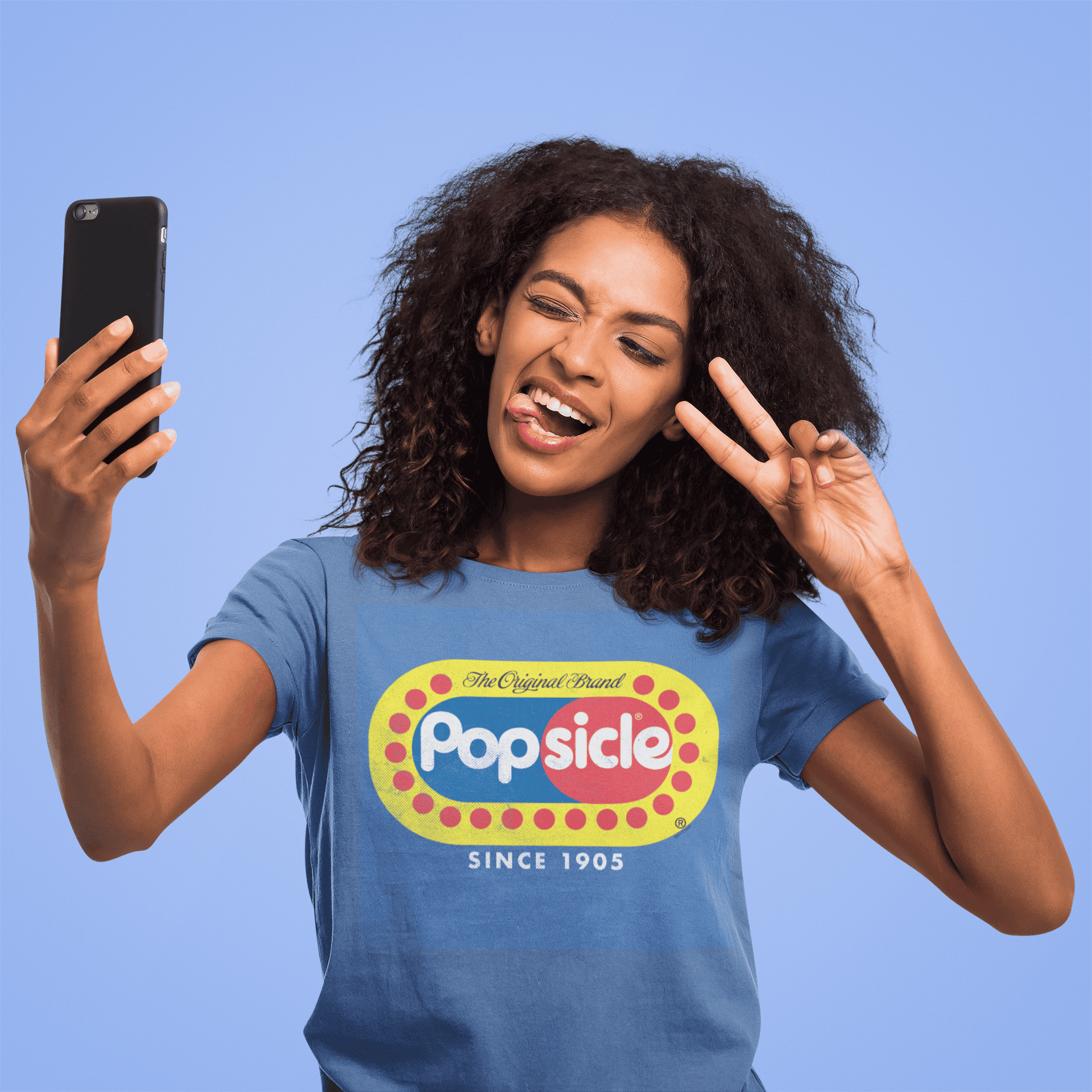 Female model wearing a Popsicle® The Original Authentic Unisex Shirt with iconic Popsicle branding and nostalgic retro graphic design.