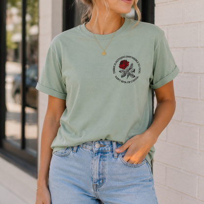 Woman wearing the Saint Rita of Cascia "There Is Nothing Impossible to God" unisex graphic T-shirt featuring the red rose chest design.