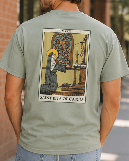 Man wearing the back of the Saint Rita of Cascia unisex graphic T-shirt featuring the vintage Saint Rita devotional illustration.