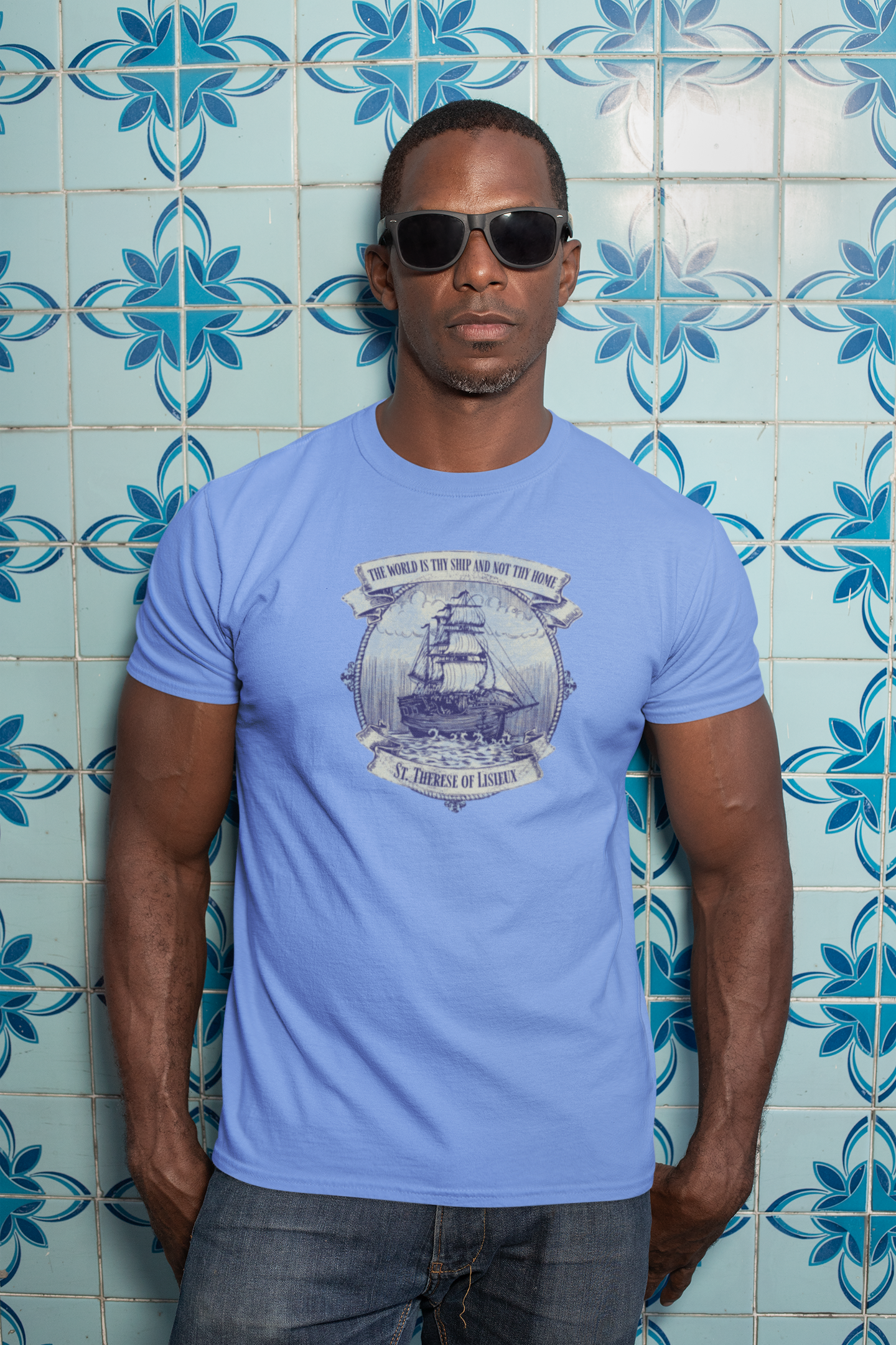 Man wearing the Saint Thérèse The World is Thy Ship religious unisex graphic T-shirt featuring inspirational Catholic artwork.