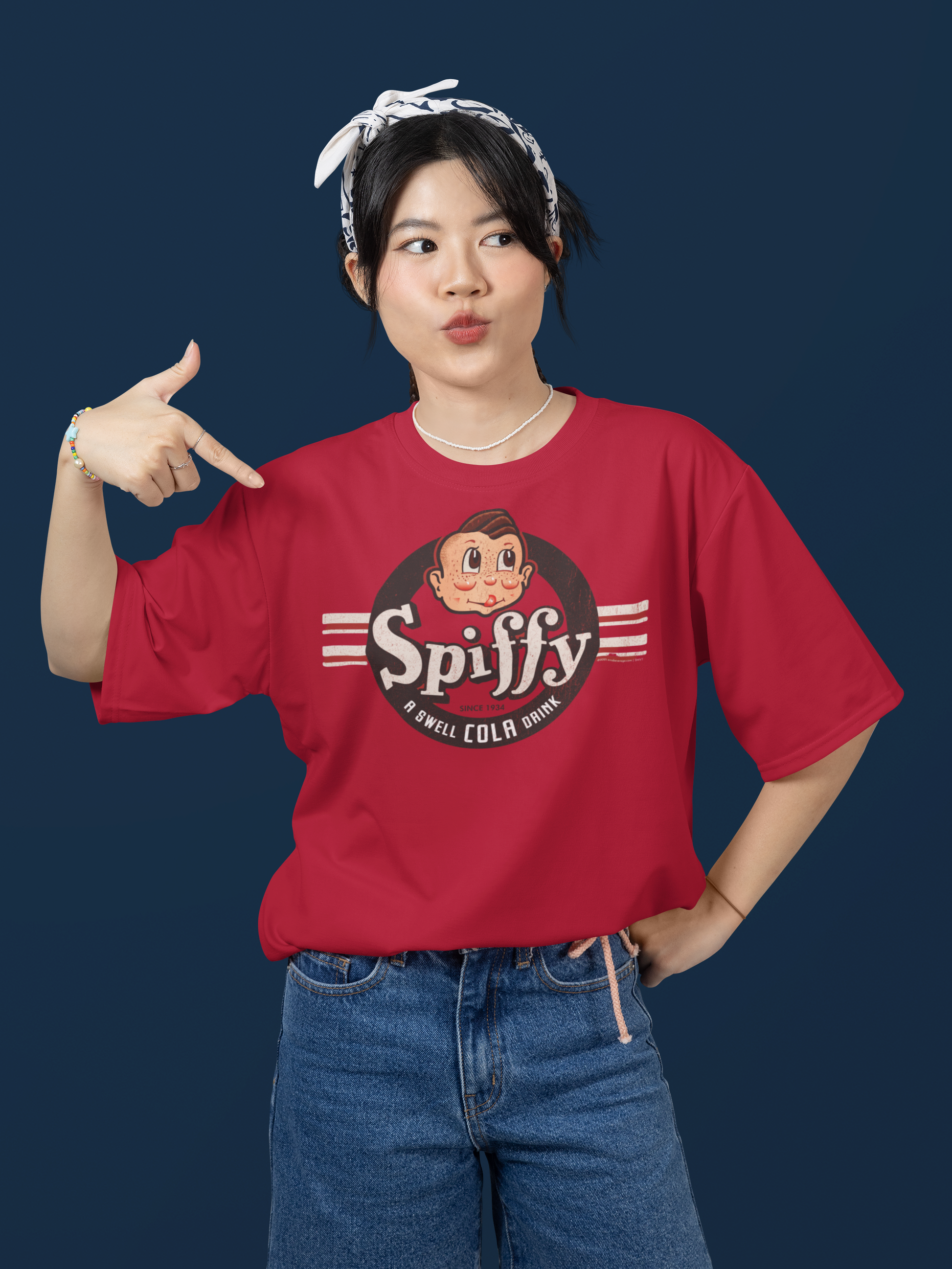 Woman wearing the Spiffy® Cola Tee featuring a vintage soda logo on a comfortable unisex graphic t-shirt.