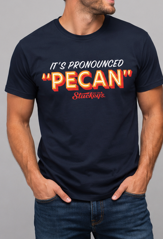 Male model wearing the Stuckey's® It's Pronounced 'Pecan' Tee, an officially licensed vintage-inspired graphic shirt celebrating America's favorite pecan stop.