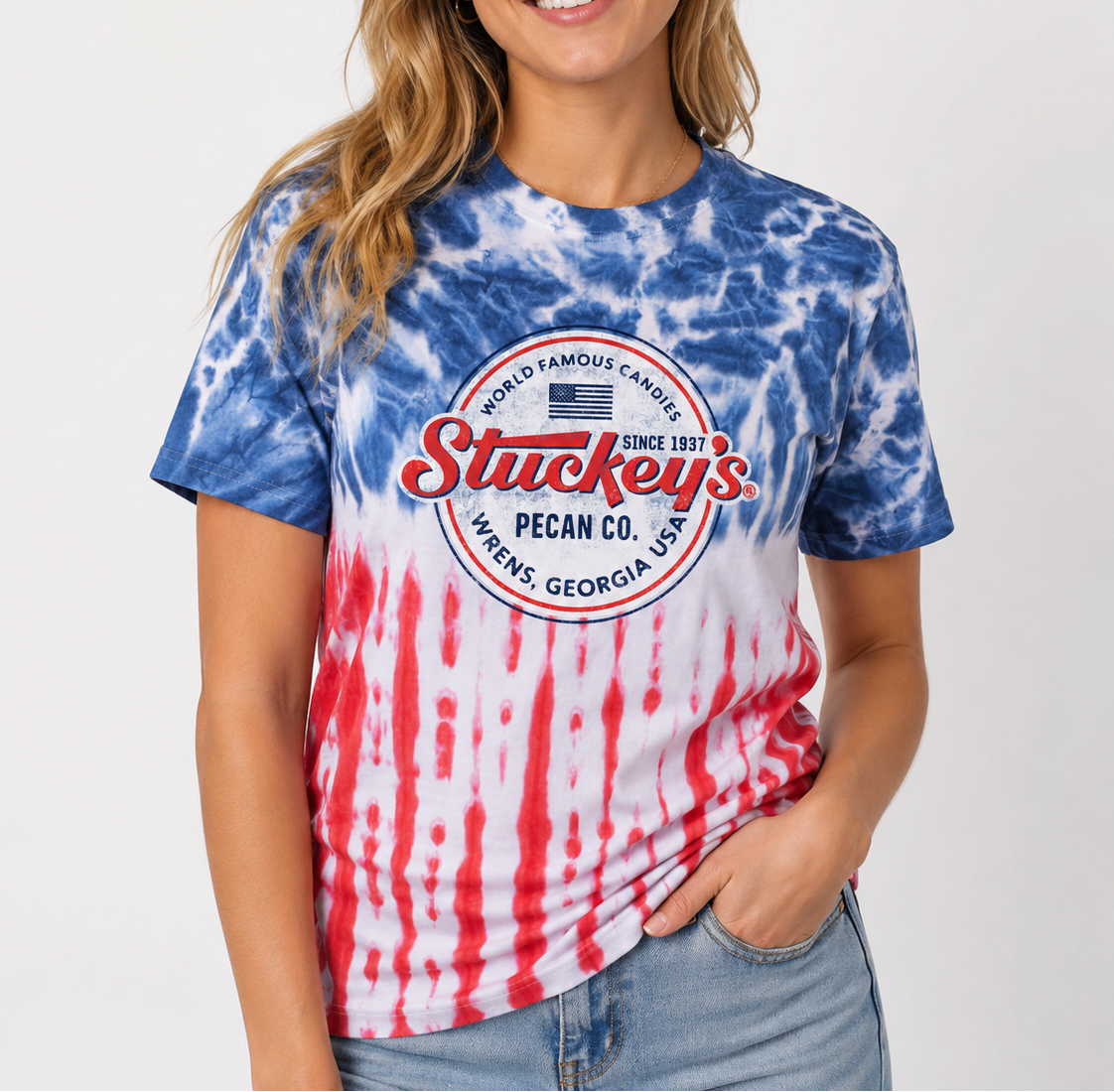 Woman wearing the Stuckey's® Made in the USA Tie-Dye Tee featuring a vintage logo and patriotic tie-dye design.