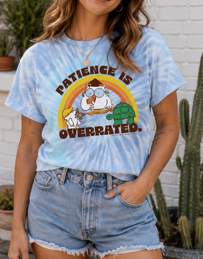 Female model wearing Tootsie Pop Patience is Overrated MR. OWL blue tie-dye T-shirt featuring retro candy graphic artwork.