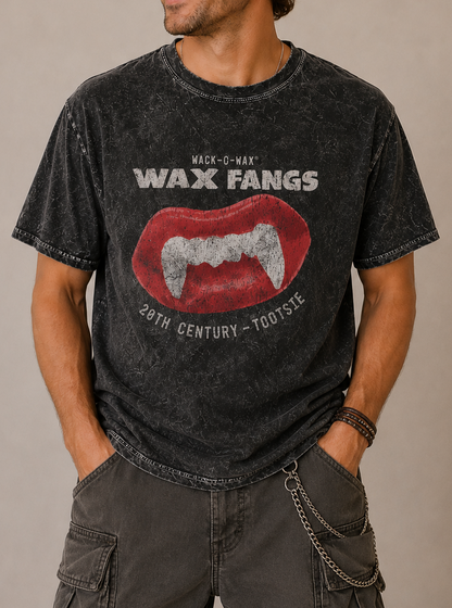 Man wearing a Wack-O-Wax FANGS Black Mineral Wash Tee showcasing retro wax vampire fangs candy graphics.