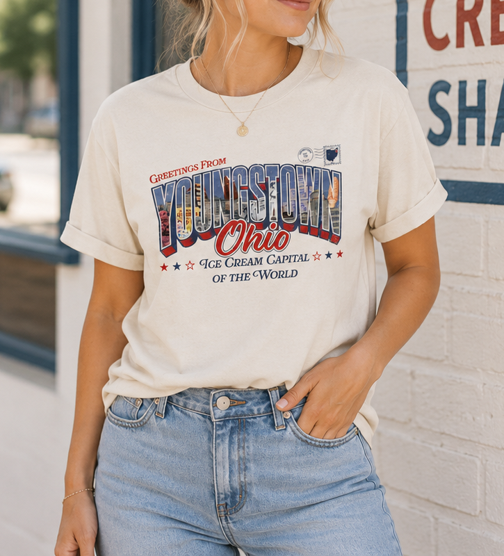 Woman wearing the SMVT Exclusive Youngstown Ohio Ice Cream Capital T-shirt featuring a retro postcard-style "Greetings from Youngstown, Ohio" design for National Ice Cream Day.