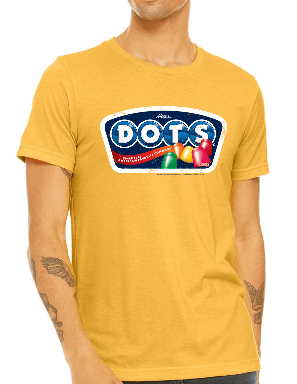 Model wearing the DOTS® Retro Gumdrops Unisex Graphic T-Shirt featuring colorful vintage-inspired candy artwork and a nostalgic retro DOTS® logo design.