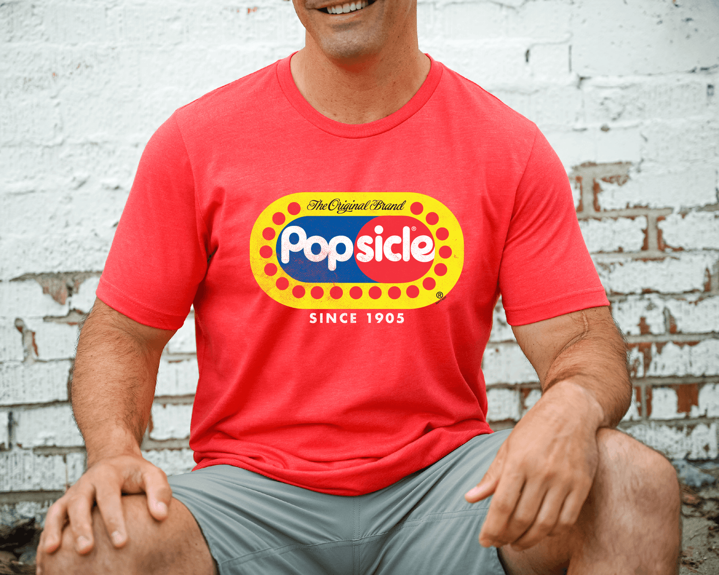 Male model wearing a Popsicle® The Original Authentic Tee featuring the classic Popsicle logo and vintage-inspired frozen treat artwork.