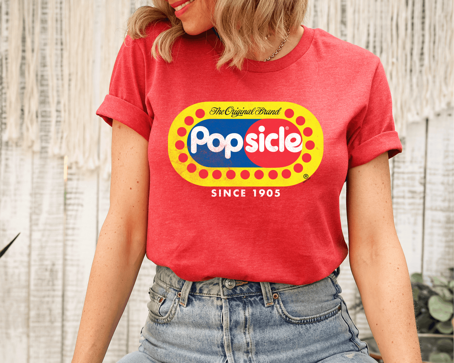 Female model wearing a Popsicle® The Original Authentic Unisex Shirt with iconic Popsicle branding and nostalgic retro graphic design.