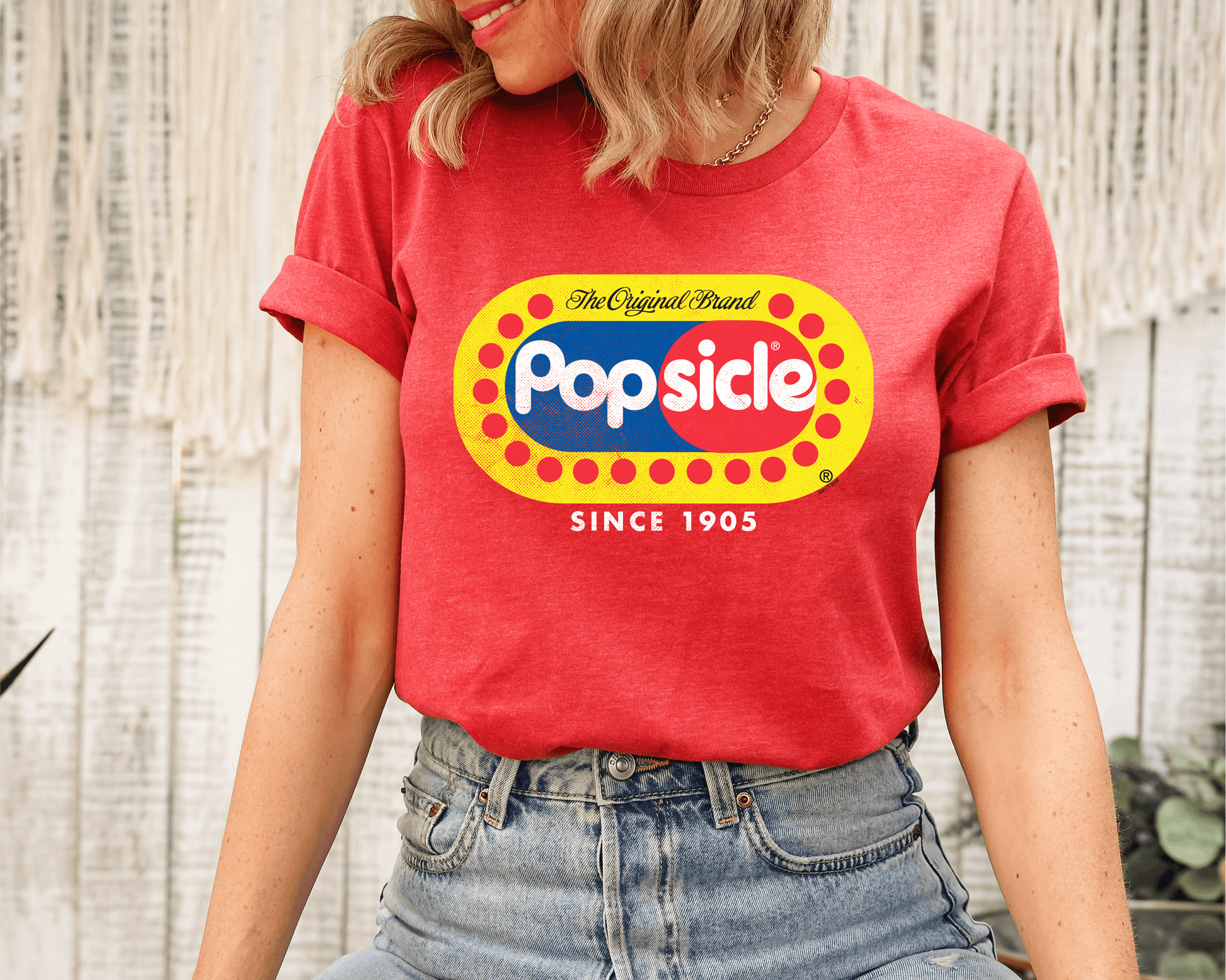 Female model wearing a Popsicle® The Original Authentic Unisex Shirt with iconic Popsicle branding and nostalgic retro graphic design.